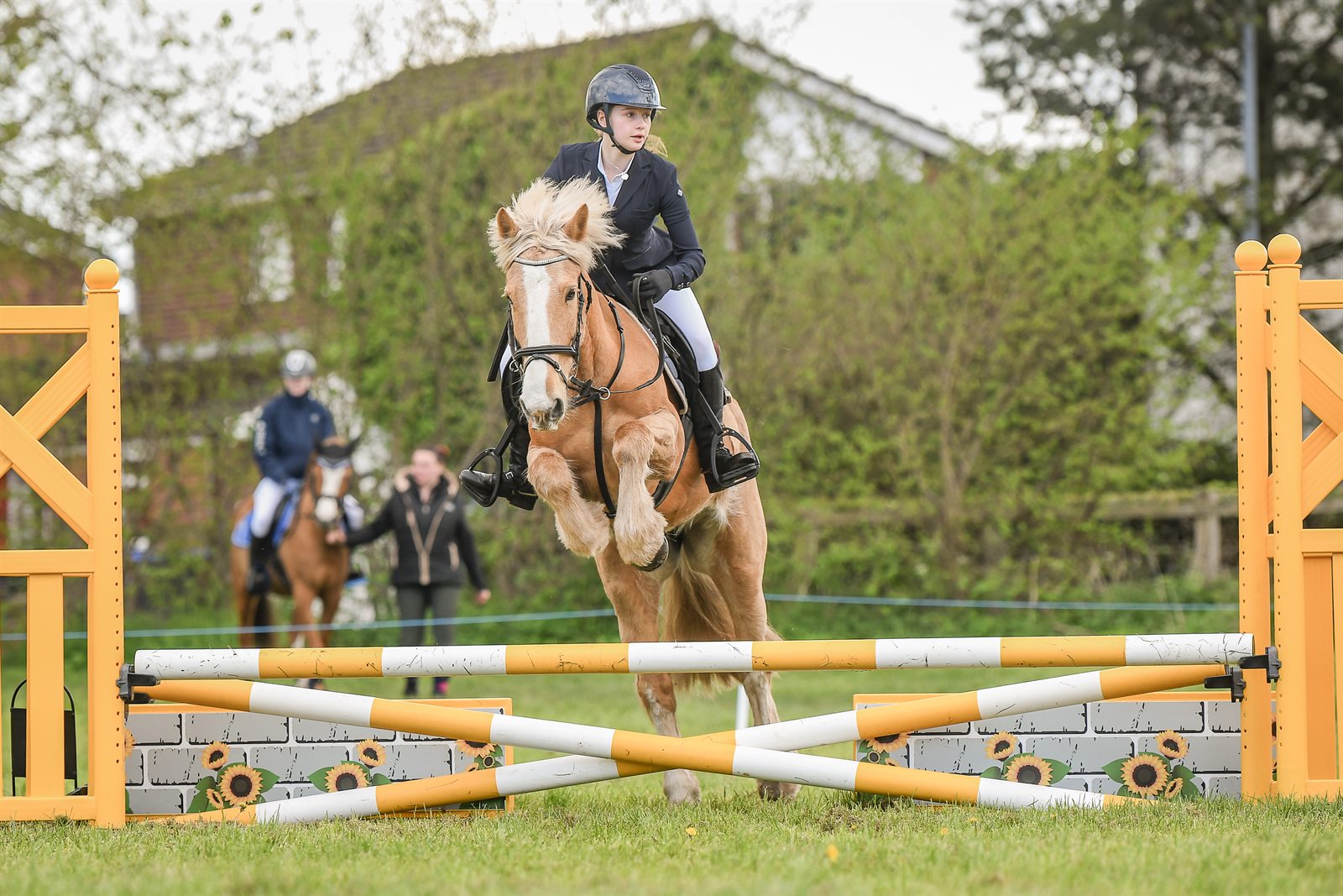A young rider and pony jumping at an outdoor Wrekin North event